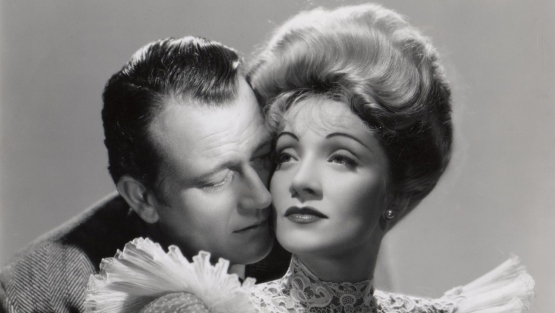 Afiche ilustrado con Marlene Dietrich y John Wayne.